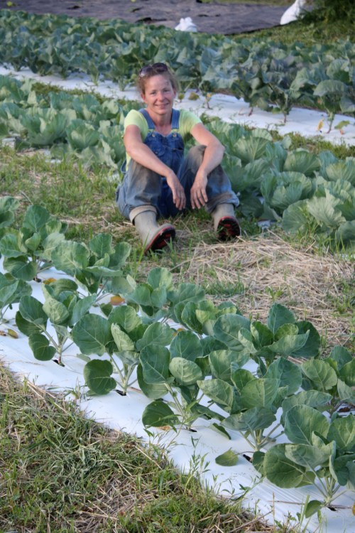 Taking a break from weeding.  Brussels sprouts in front of me and cabbage behind.