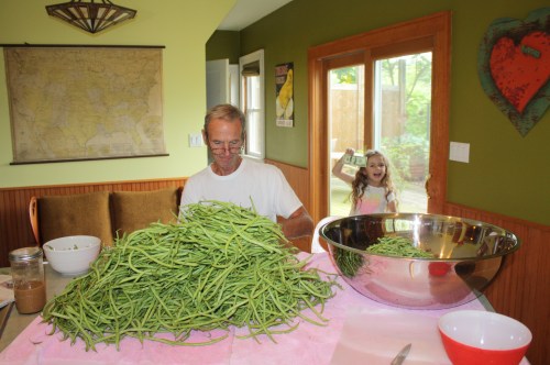 Scott cutting beans for canning and Maeve offering him a few bucks as an insentive.